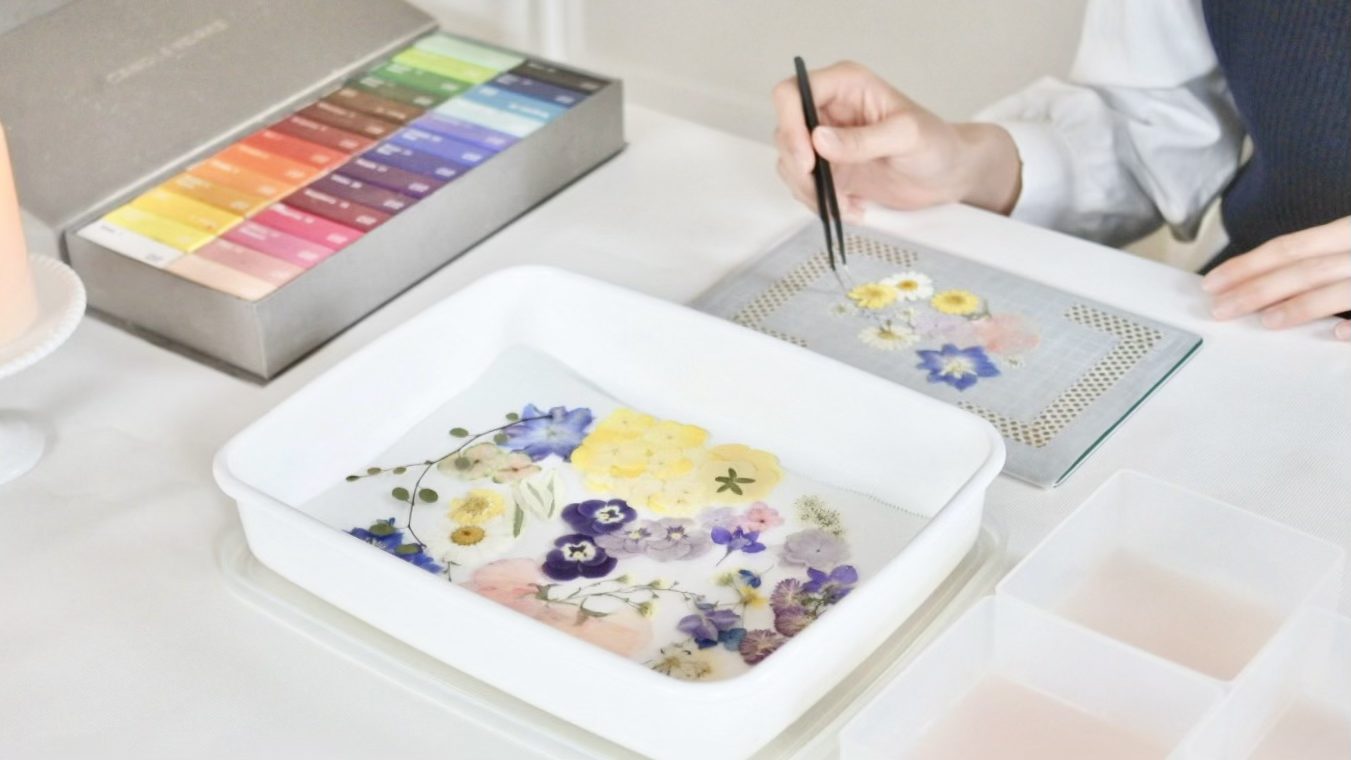 Satomi Yano placing pressed flowers by hand