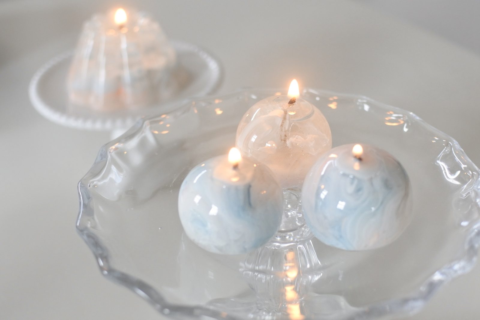 Marble Orb — three candles lit together